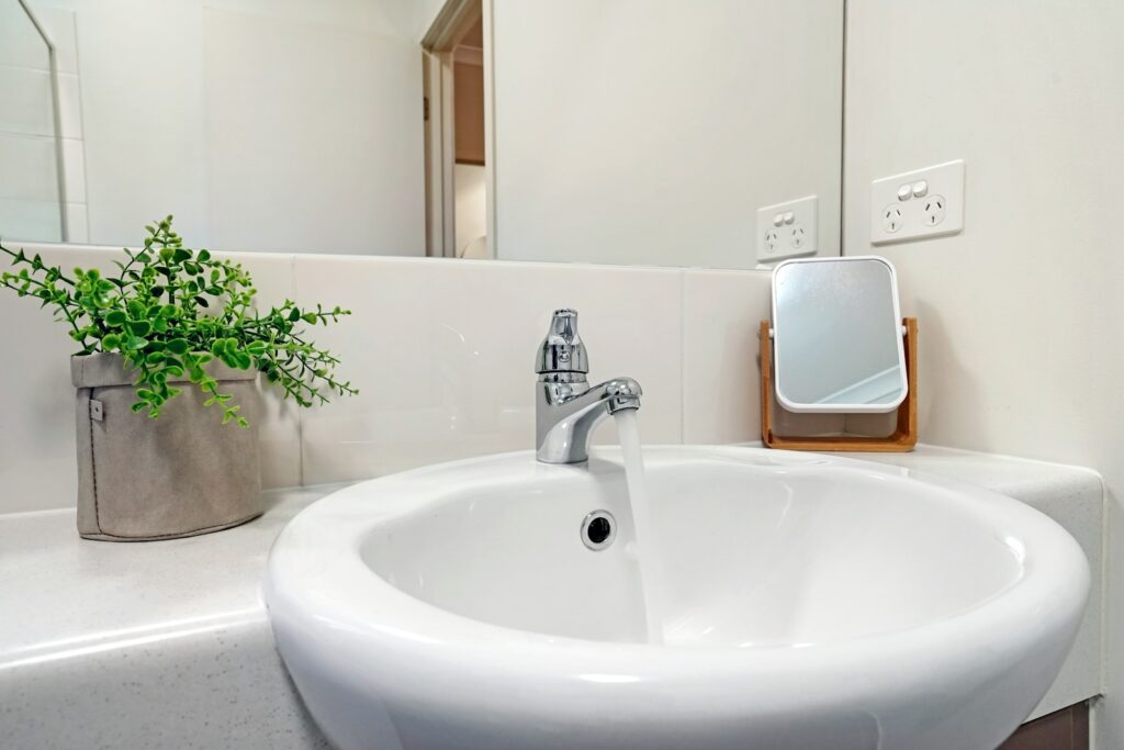 white ceramic sink with stainless steel faucet